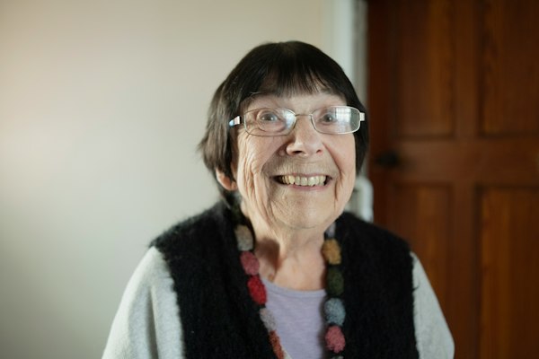 An older woman in glasses smiling